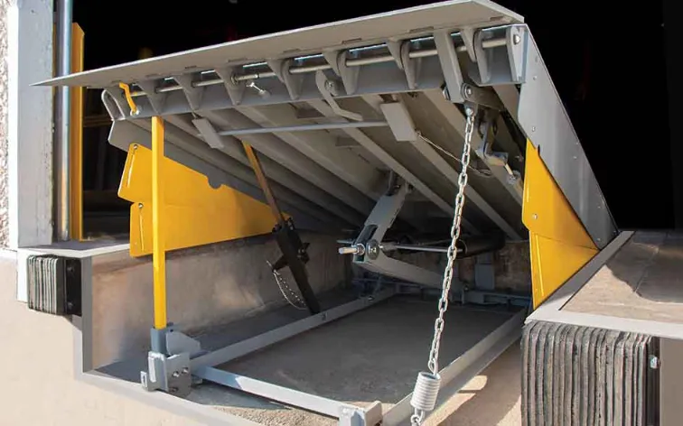 Mechanical dock leveler in an open position, designed for efficient loading and unloading, featuring safety chains and a sturdy frame, relevant to commercial dock equipment solutions.