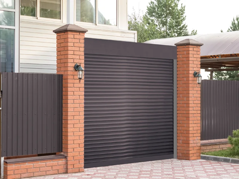Garage door with brick pillars and side fencing, emphasizing safety and security for residential properties.