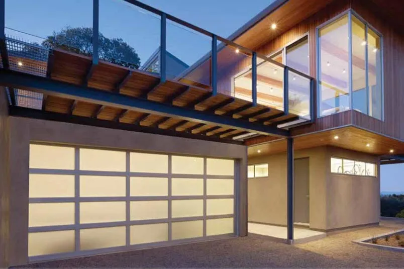 Modern aluminum garage door with sleek design and glass panels, complementing contemporary home architecture in a stylish exterior setting.