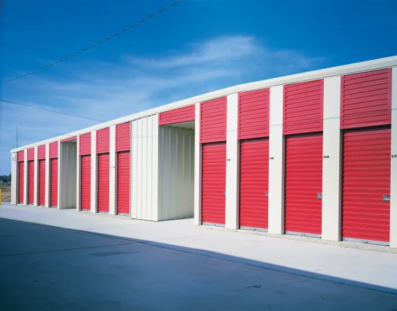 Rolling sheet doors in a commercial setting, featuring red and white colors, showcasing secure storage solutions for businesses.
