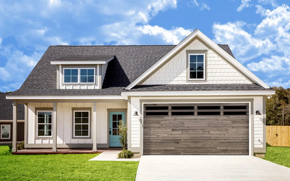 Modern residential home featuring a stylish garage door with wood-like design, enhancing curb appeal and security for homeowners in Fresno.