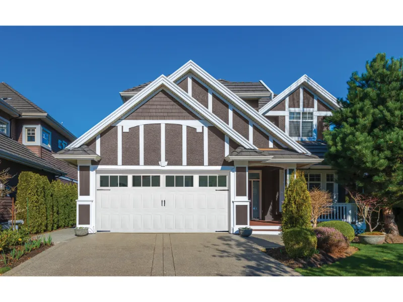 Modern home exterior featuring a stylish garage door, showcasing a clean design and well-maintained landscaping, relevant to Overhead Door Company of Fresno's garage door installation portfolio.