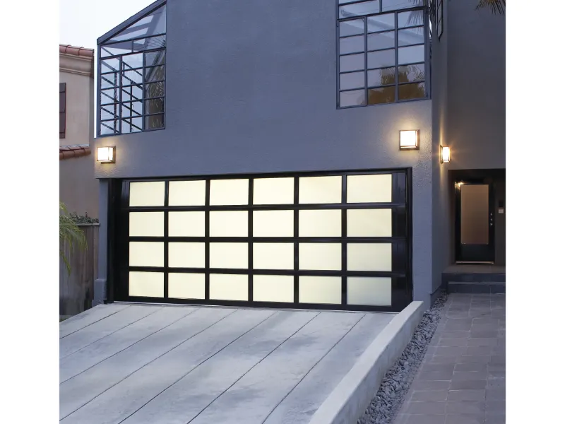 Modern aluminum garage door with frosted glass panels, showcasing sleek design in residential setting, emphasizing Overhead Door Company of Fresno's transformation expertise.