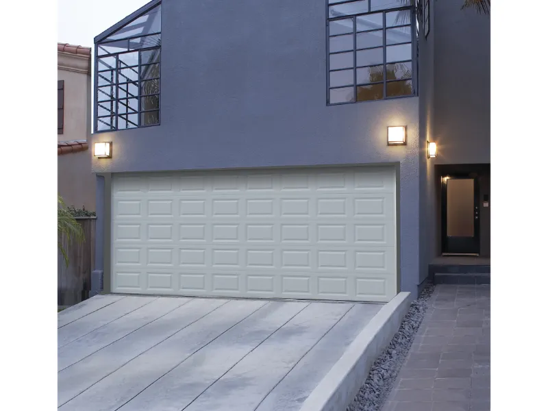 Garage door with a modern design, enhancing curb appeal, situated on a stylish residential home in Fresno, showcasing architectural features and exterior lighting.